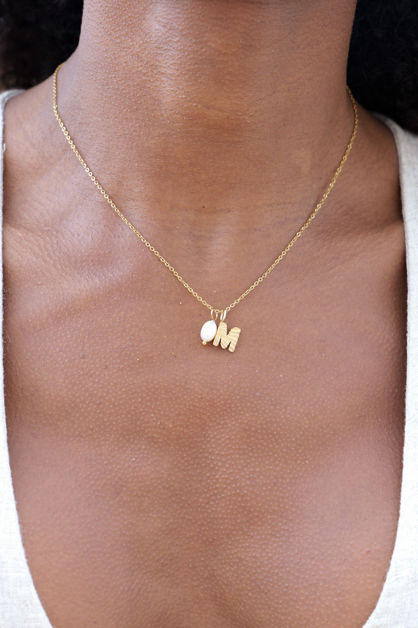 Gold sunbeam initial necklace
