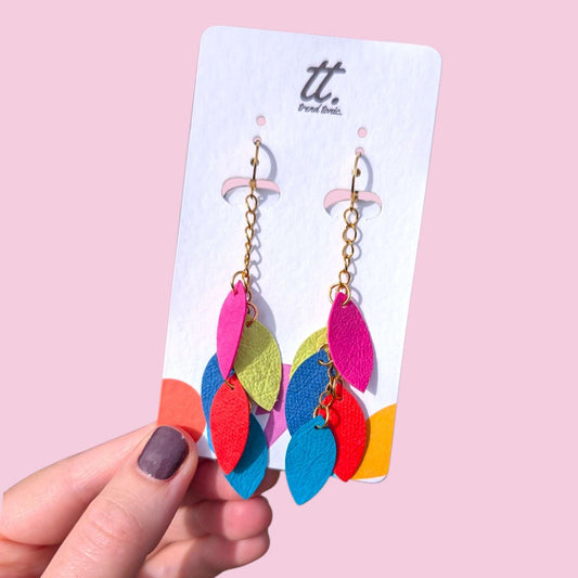 a hand holding a pair of earrings