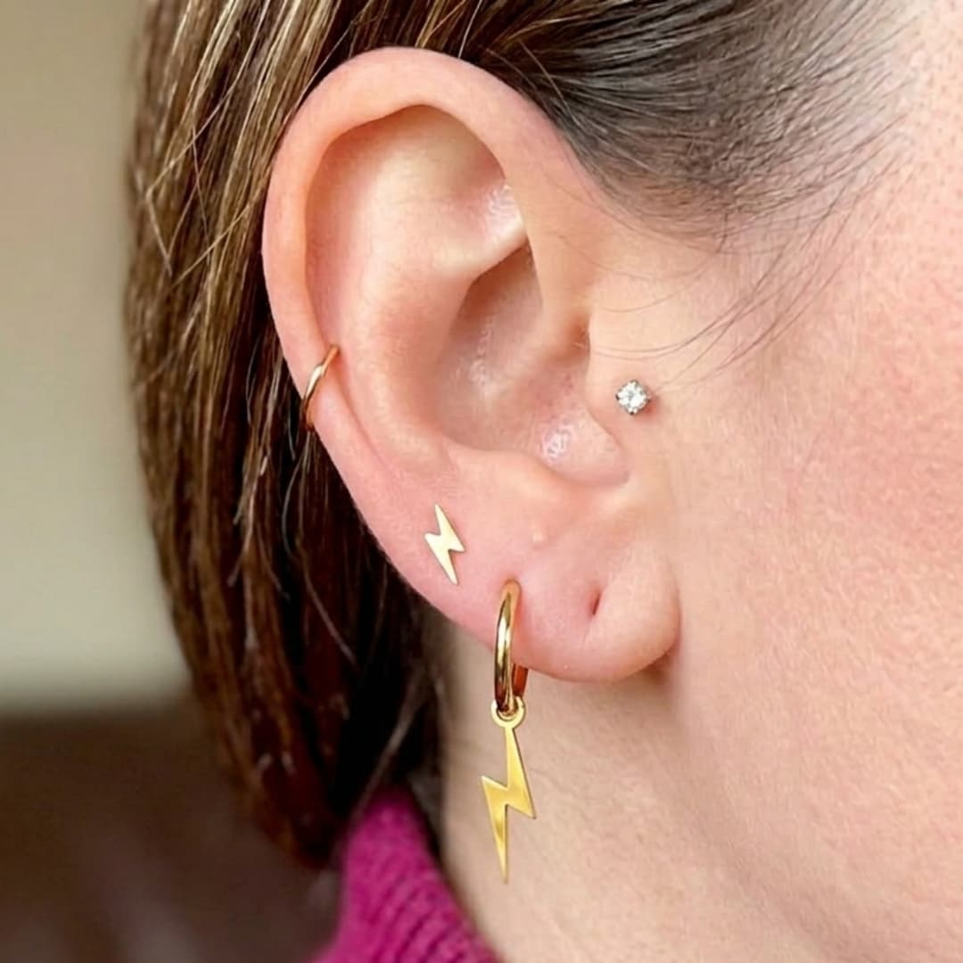 a woman's ear with earrings