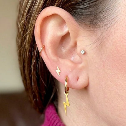 a woman's ear with earrings