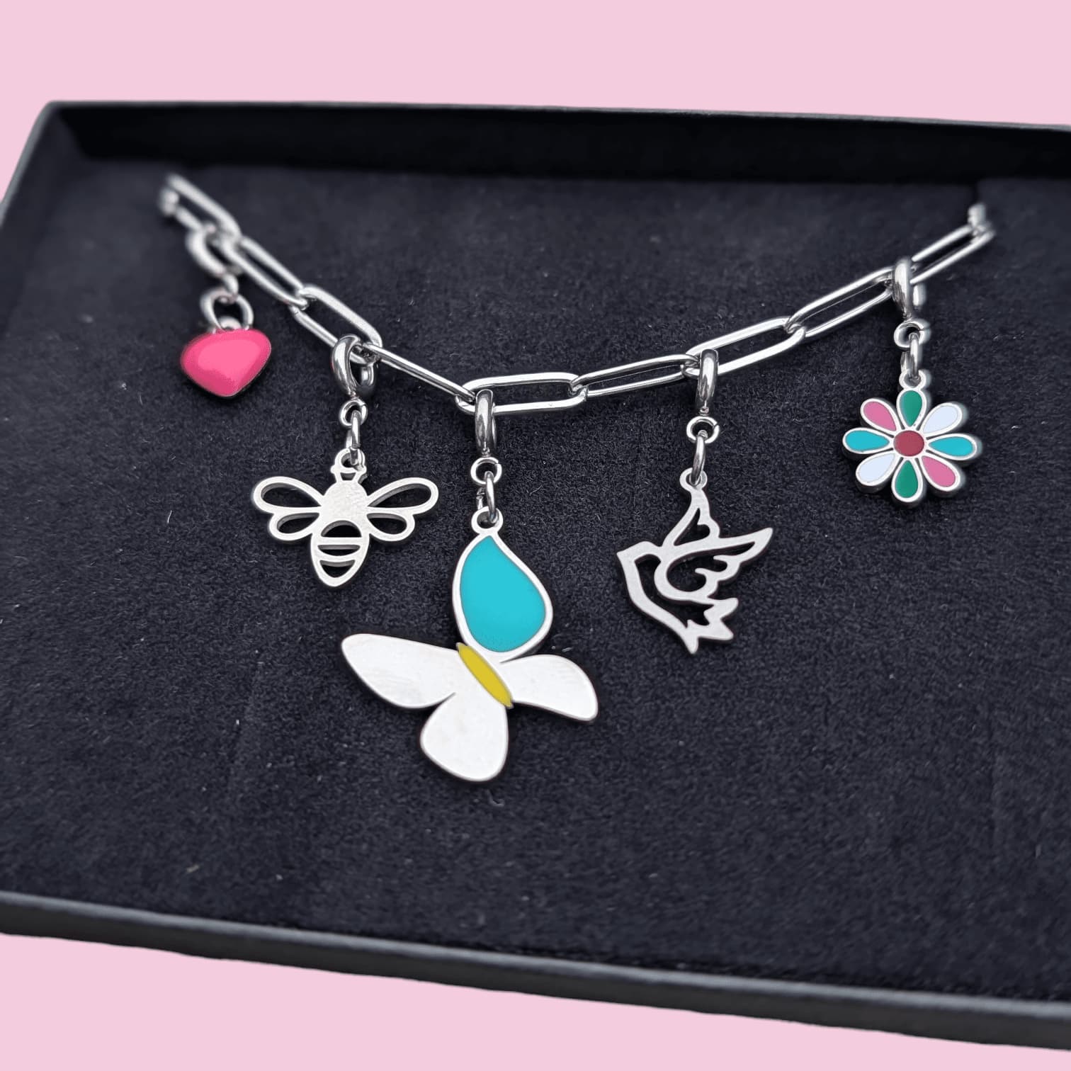 a necklace with charms in a box