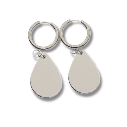 a pair of earrings on a white background