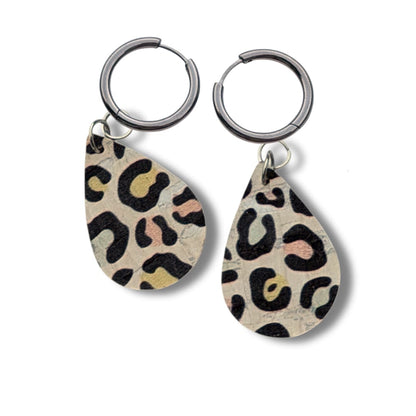 a pair of earrings with leopard print