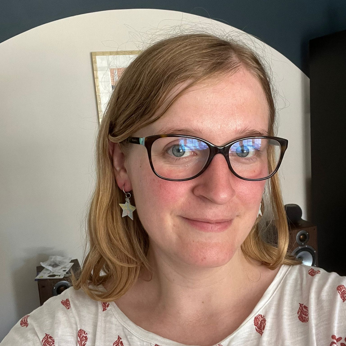 a woman wearing glasses and a white shirt