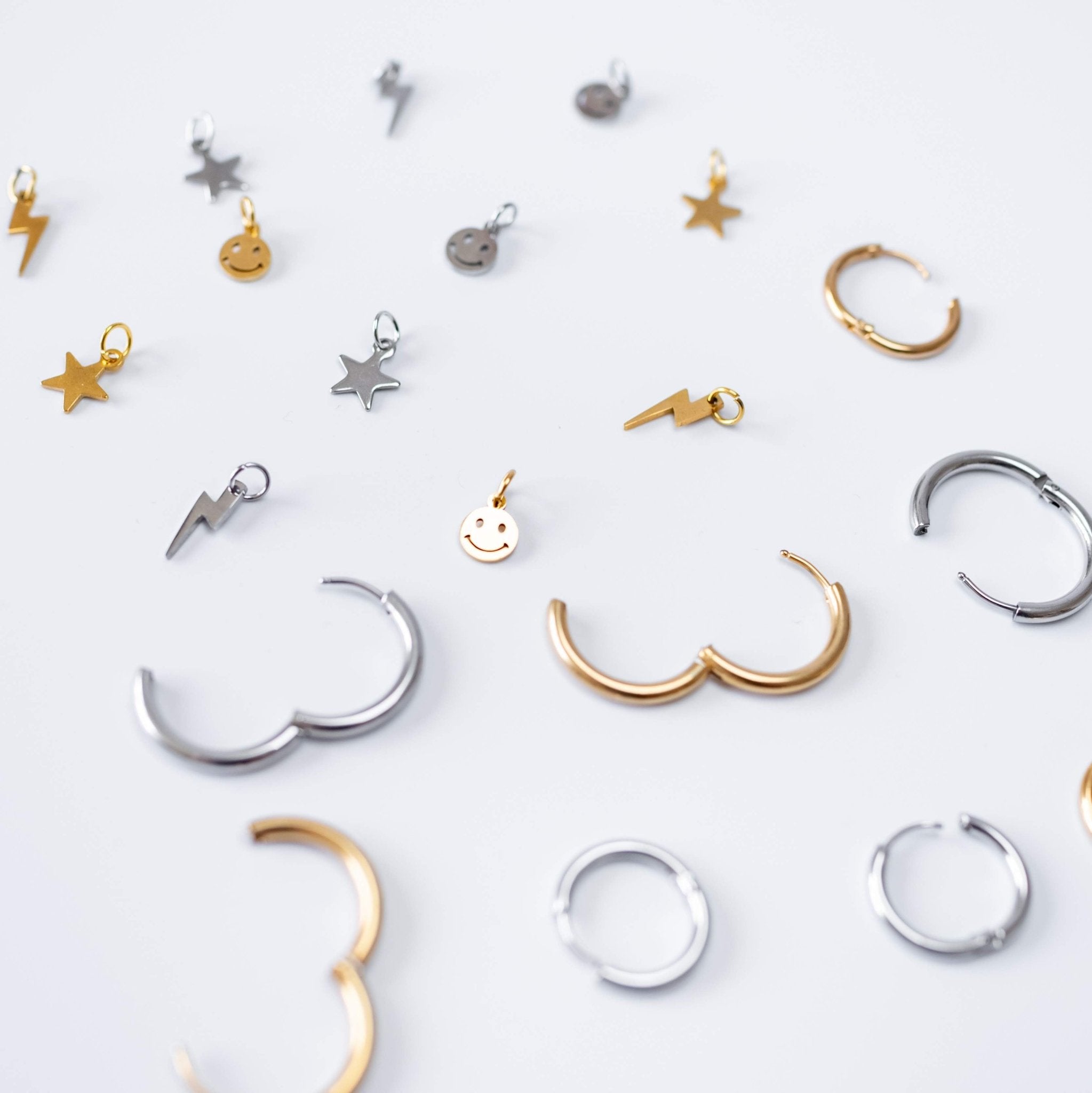 a group of gold and silver earrings