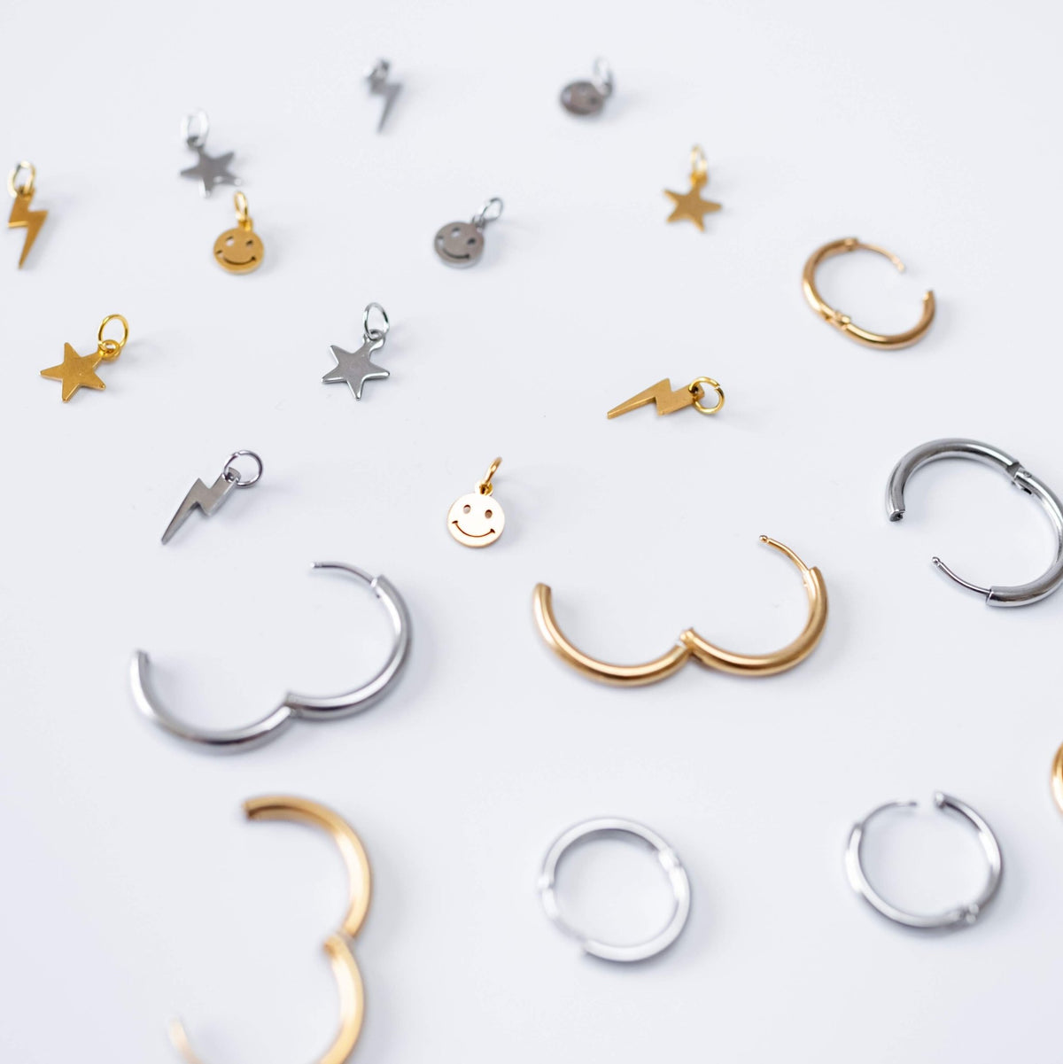 a group of gold and silver earrings