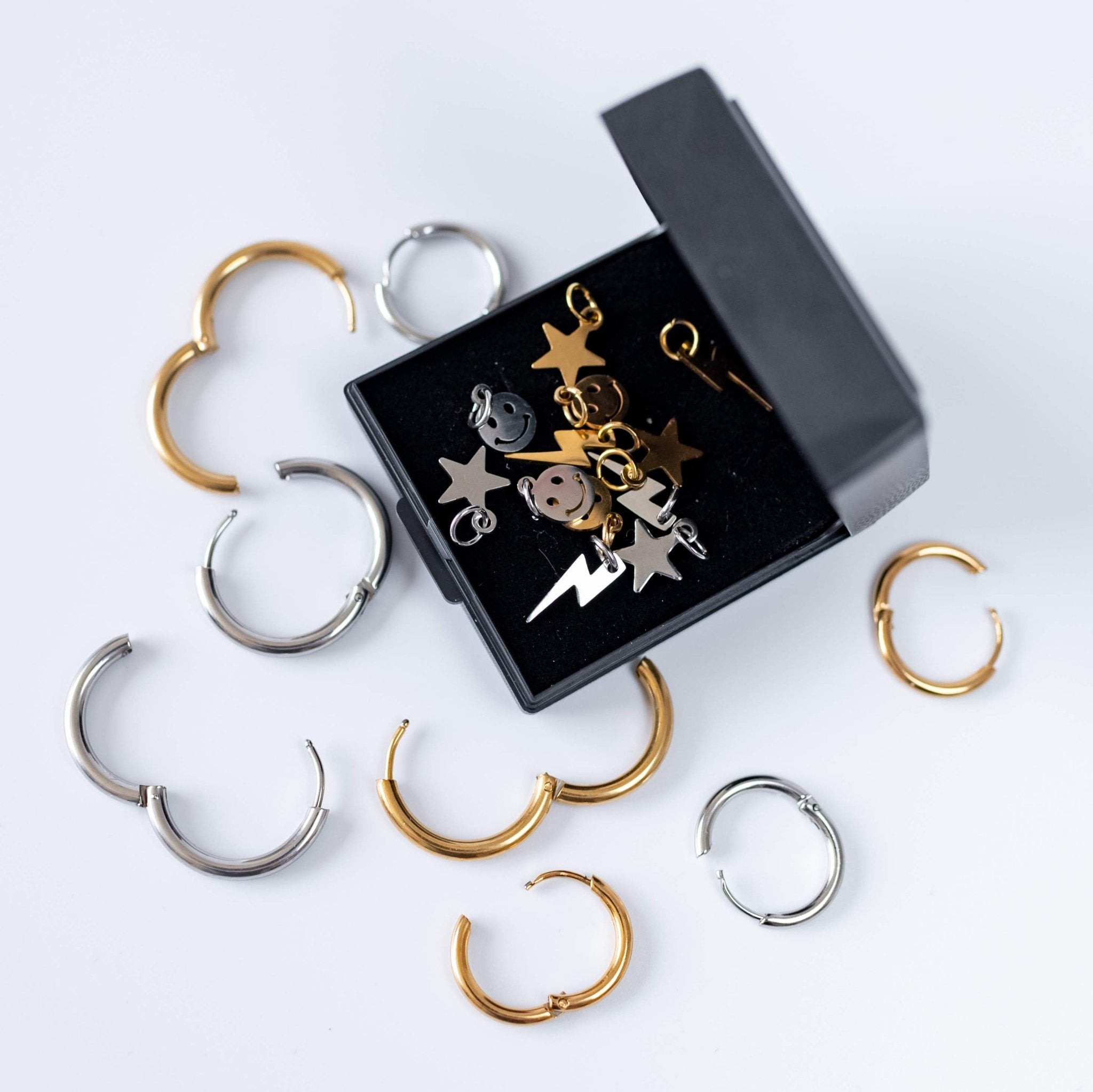 a box with gold and silver earrings