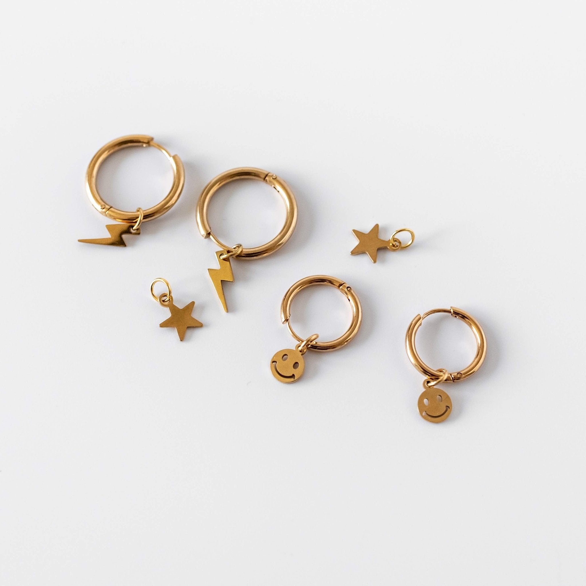 a group of gold earrings