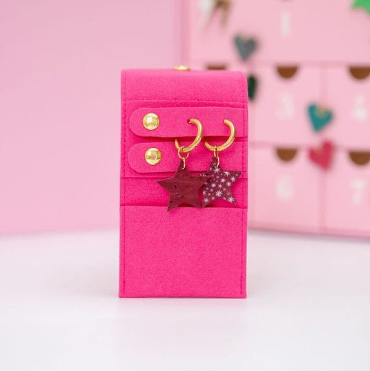 a pink box with earrings on it