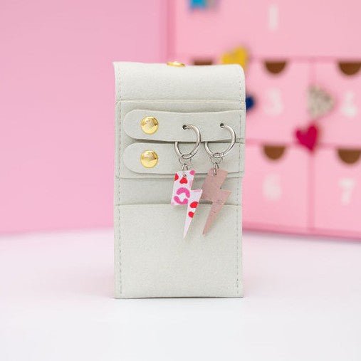 a small white purse with a lightning bolt and a key chain